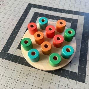 Lovevery wooden stacking Montessori pegboard toy.